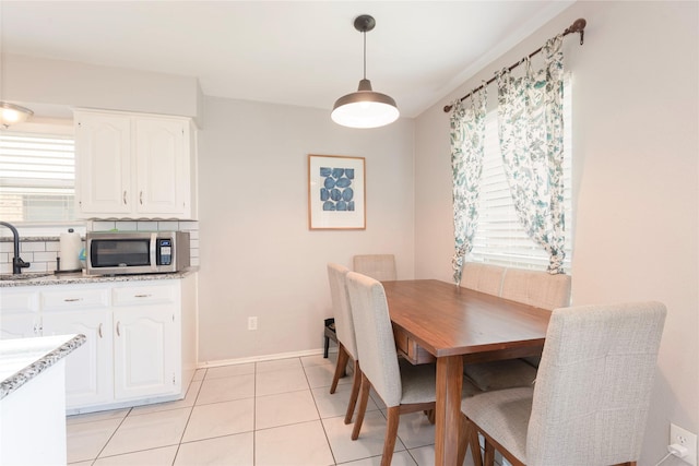 1654 Clarendon Dr, Lewisville, TX 75067 - dining area with light tile patterned floors and baseboards