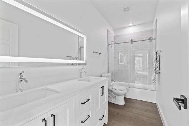 3620 Quail Ln, Arlington, TX 76016 - full bathroom featuring toilet, shower / bath combination with glass door, double vanity, wood finished floors, and recessed lighting