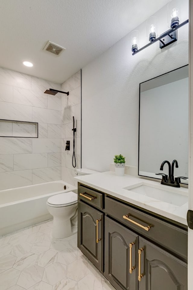 15525 Western Trl, Frisco, TX 75035 - bathroom with vanity, toilet,  shower combination, marble look tile flooring, and a textured ceiling