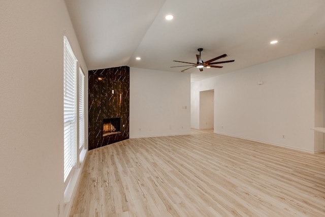 15525 Western Trl, Frisco, TX 75035 - unfurnished living room with ceiling fan, vaulted ceiling, a high end fireplace, recessed lighting, and light wood-style flooring