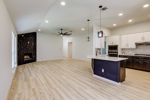 15525 Western Trl, Frisco, TX 75035 - kitchen with stainless steel microwave, wall oven, a sink, white cabinetry, and stovetop