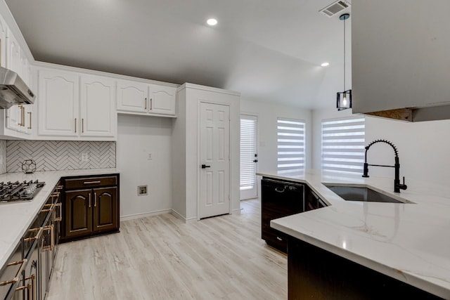 15525 Western Trl, Frisco, TX 75035 - kitchen featuring a sink, dishwasher, light stone counters, light wood-style floors, and decorative backsplash