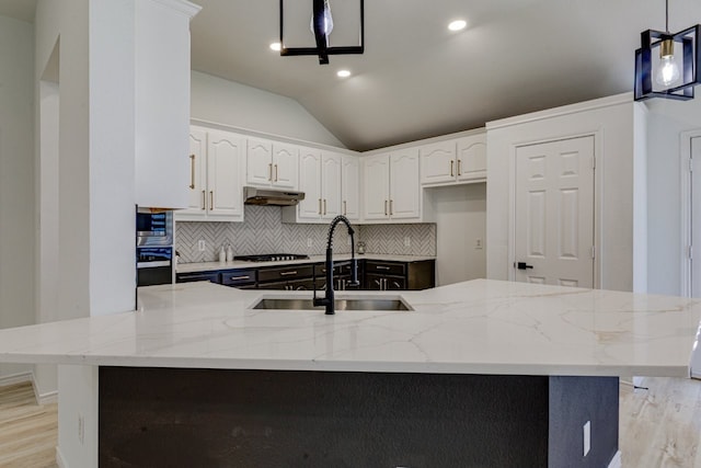 15525 Western Trl, Frisco, TX 75035 - kitchen featuring a sink, backsplash, gas cooktop, under cabinet range hood, and light wood-style floors