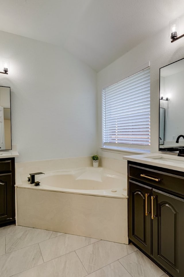 15525 Western Trl, Frisco, TX 75035 - full bath featuring vanity, a bath, lofted ceiling, and marble finish flooring