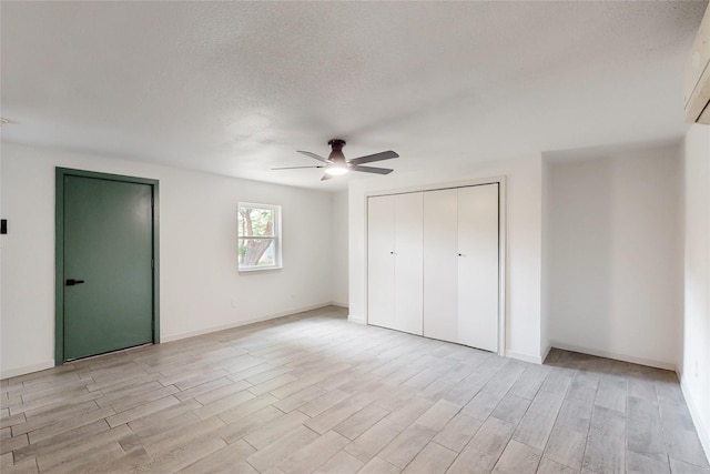409 Fleming Dr, Hurst, TX 76053 - unfurnished bedroom with light wood-style flooring, ceiling fan, a textured ceiling, baseboards, and a closet