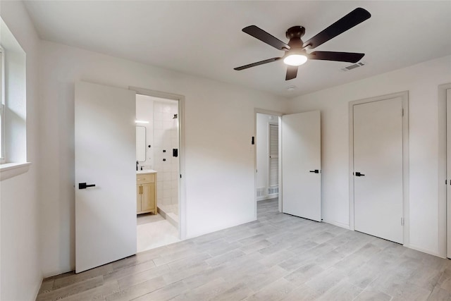 409 Fleming Dr, Hurst, TX 76053 - unfurnished bedroom with light wood-style flooring, connected bathroom, and ceiling fan