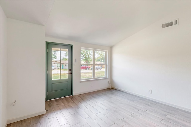 409 Fleming Dr, Hurst, TX 76053 - empty room with lofted ceiling, light wood-style flooring, and baseboards