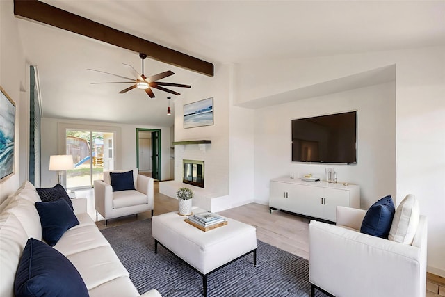 409 Fleming Dr, Hurst, TX 76053 - living room featuring ceiling fan, wood finished floors, a glass covered fireplace, and baseboards