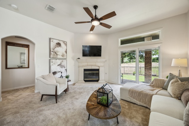 308 Wrangler Dr, Fairview, TX 75069 - living area featuring light carpet, ceiling fan, a glass covered fireplace, and baseboards