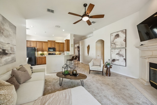 308 Wrangler Dr, Fairview, TX 75069 - living room featuring light colored carpet, arched walkways, a ceiling fan, a high end fireplace, and recessed lighting