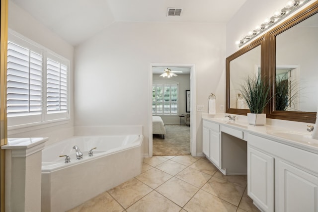308 Wrangler Dr, Fairview, TX 75069 - ensuite bathroom with double vanity, a garden tub, a ceiling fan, vaulted ceiling, and tile patterned flooring