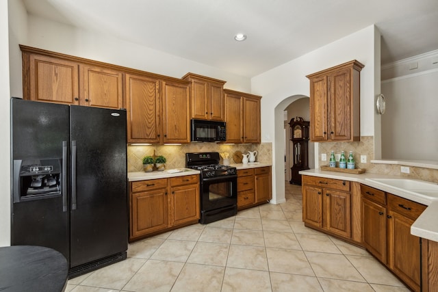308 Wrangler Dr, Fairview, TX 75069 - kitchen featuring black appliances, arched walkways, brown cabinets, ornamental molding, and recessed lighting