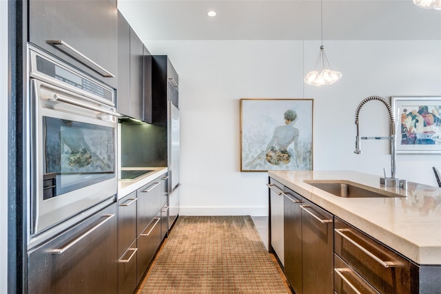 2200 Victory Ave Unit 701, Dallas, TX 75219 - kitchen with a sink, modern cabinets, baseboards, hanging light fixtures, and light countertops