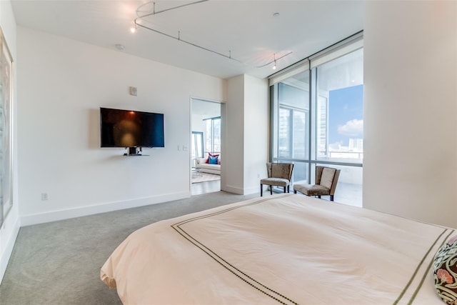 2200 Victory Ave Unit 701, Dallas, TX 75219 - carpeted bedroom featuring rail lighting and baseboards