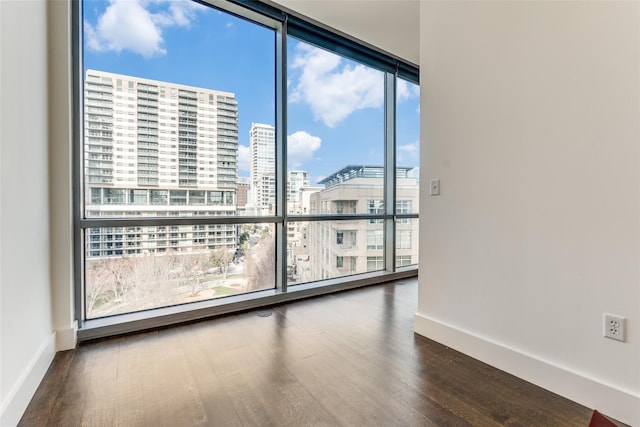 2200 Victory Ave Unit 701, Dallas, TX 75219 - spare room featuring a view of city, wood finished floors, floor to ceiling windows, and baseboards