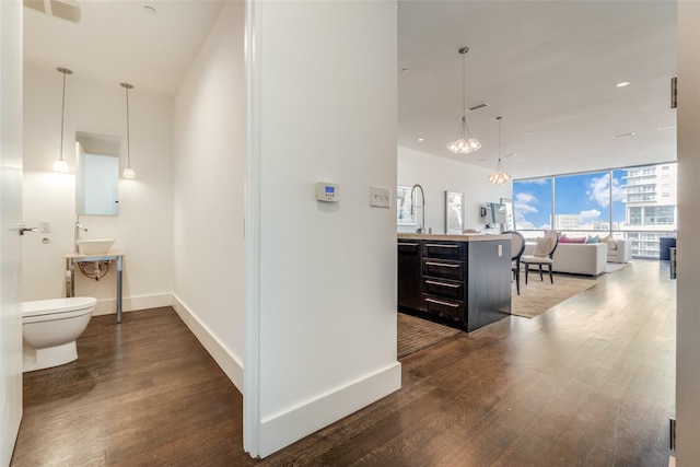 2200 Victory Ave Unit 701, Dallas, TX 75219 - hall featuring dark wood-style floors, baseboards, and recessed lighting
