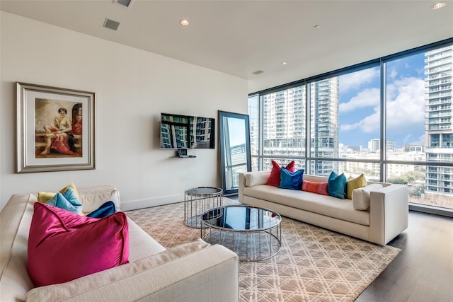 2200 Victory Ave Unit 701, Dallas, TX 75219 - living room with a view of city, wood finished floors, baseboards, recessed lighting, and floor to ceiling windows