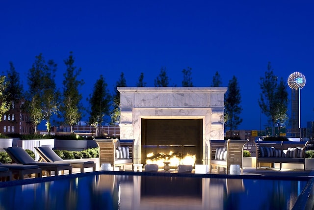 2200 Victory Ave Unit 701, Dallas, TX 75219 - pool at twilight featuring a premium fireplace