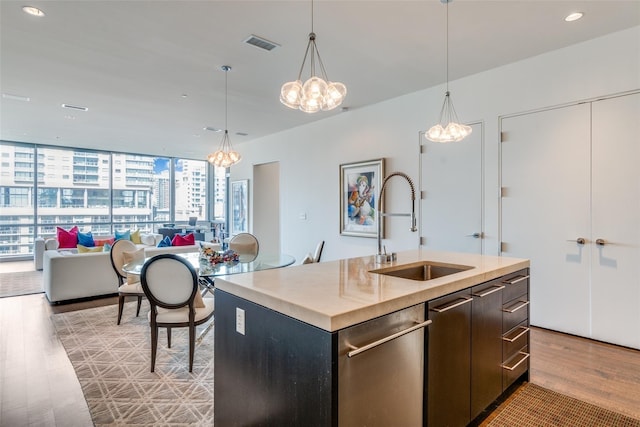 2200 Victory Ave Unit 701, Dallas, TX 75219 - kitchen featuring a sink, a chandelier, dishwasher, light wood-style floors, and recessed lighting
