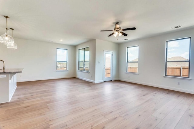 533 Hillcrest Cir, Justin, TX 76247 - unfurnished living room featuring plenty of natural light, a ceiling fan, baseboards, and recessed lighting