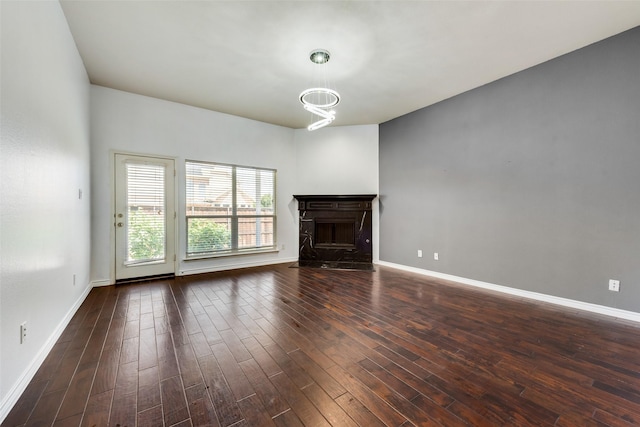 13293 Grayhawk Blvd, Frisco, TX 75033 - unfurnished living room with a fireplace, wood finished floors, baseboards, and a chandelier