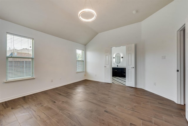 13293 Grayhawk Blvd, Frisco, TX 75033 - unfurnished living room featuring vaulted ceiling, baseboards, and wood finished floors