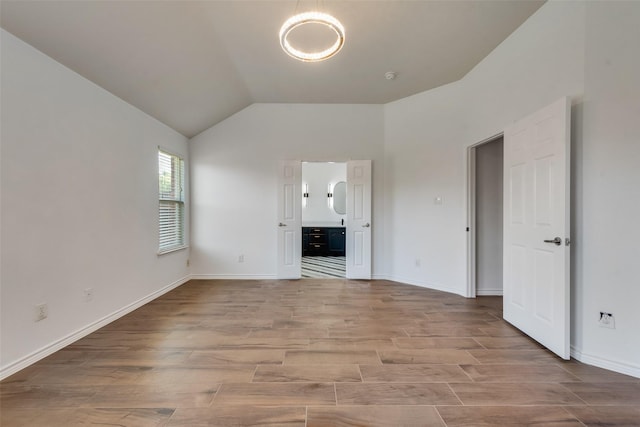 13293 Grayhawk Blvd, Frisco, TX 75033 - empty room with wood finished floors, vaulted ceiling, and baseboards