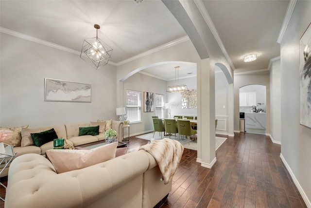 13293 Grayhawk Blvd, Frisco, TX 75033 - living room with arched walkways, a chandelier, dark wood-style flooring, baseboards, and crown molding