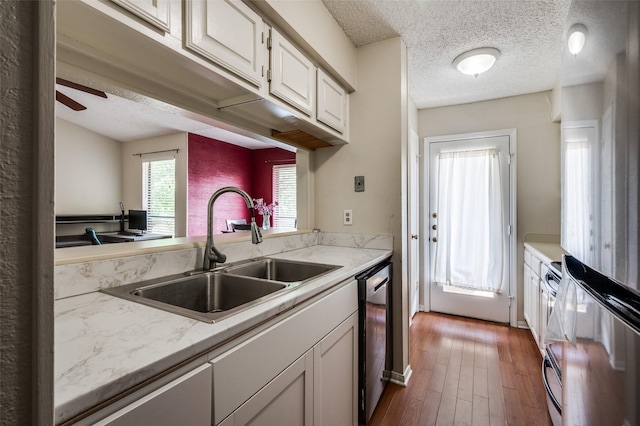 1301 Memory Ln Unit 4920, Arlington, TX 76011 - kitchen featuring a sink, freestanding refrigerator, a textured ceiling, white cabinetry, and dishwasher