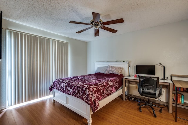 1301 Memory Ln Unit 4920, Arlington, TX 76011 - bedroom with wood finished floors, a textured ceiling, and ceiling fan
