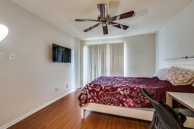 1301 Memory Ln Unit 4920, Arlington, TX 76011 - bedroom featuring wood finished floors, a textured ceiling, baseboards, and ceiling fan
