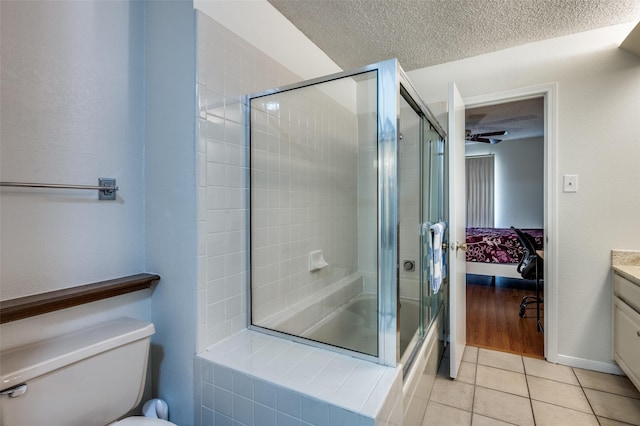 1301 Memory Ln Unit 4920, Arlington, TX 76011 - ensuite bathroom featuring a textured ceiling, vanity, toilet, tile patterned flooring, and combined bath / shower with glass door