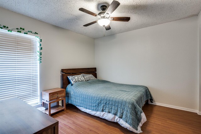 1301 Memory Ln Unit 4920, Arlington, TX 76011 - bedroom with wood finished floors, baseboards, a textured ceiling, and ceiling fan