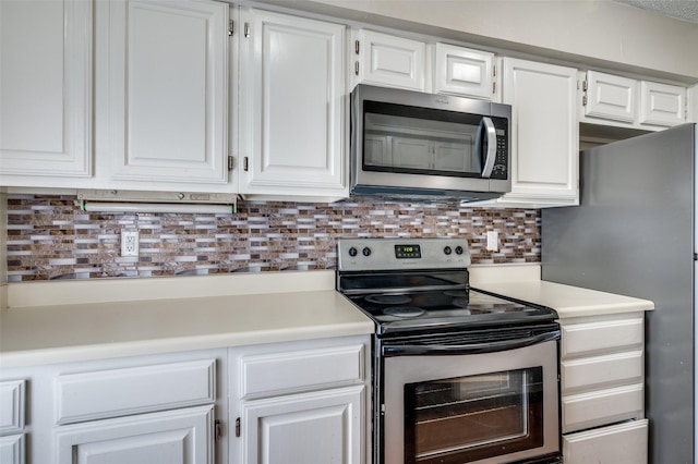 1301 Memory Ln Unit 4920, Arlington, TX 76011 - kitchen featuring appliances with stainless steel finishes, white cabinets, light countertops, and decorative backsplash