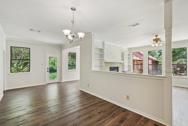2224 Bluff Ct, Cedar Hill, TX 75104 - unfurnished living room featuring a tiled fireplace, healthy amount of natural light, a chandelier, and ornamental molding