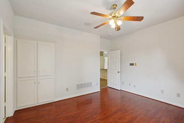 2224 Bluff Ct, Cedar Hill, TX 75104 - unfurnished bedroom featuring dark wood-style floors, baseboards, and a ceiling fan