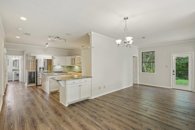 2224 Bluff Ct, Cedar Hill, TX 75104 - kitchen featuring stainless steel fridge with ice dispenser, ornamental molding, a kitchen island, white cabinets, and dark wood-type flooring