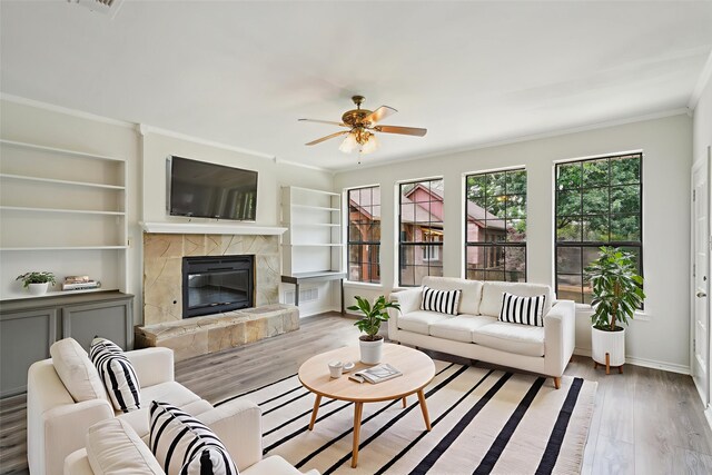 2224 Bluff Ct, Cedar Hill, TX 75104 - living room featuring ornamental molding, wood finished floors, ceiling fan, a high end fireplace, and baseboards