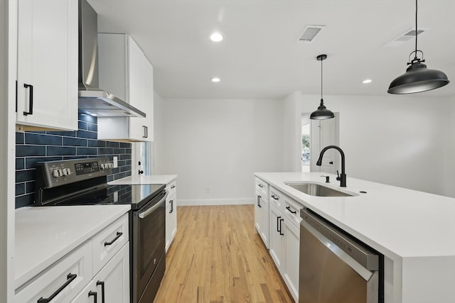 10626 Desdemona Dr, Dallas, TX 75228 - kitchen featuring stainless steel appliances, a sink, wall chimney range hood, light wood-type flooring, and tasteful backsplash