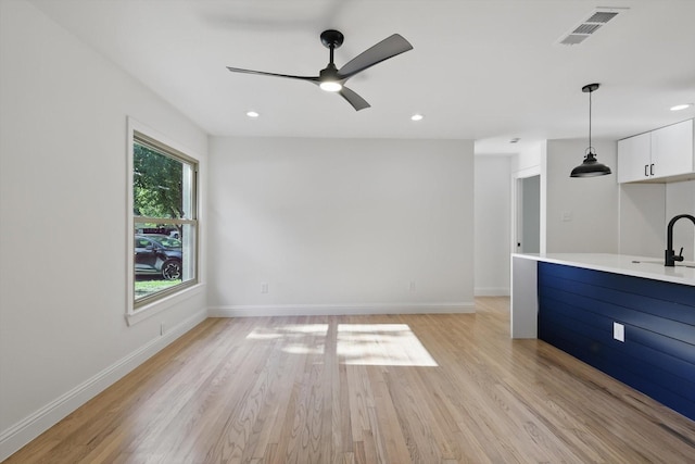 10626 Desdemona Dr, Dallas, TX 75228 - unfurnished living room featuring light wood-type flooring, recessed lighting, baseboards, a ceiling fan, and a sink