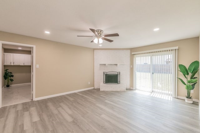 2400 Clearwood Dr, Arlington, TX 76014 - unfurnished living room with ceiling fan, recessed lighting, wood finished floors, baseboards, and a brick fireplace