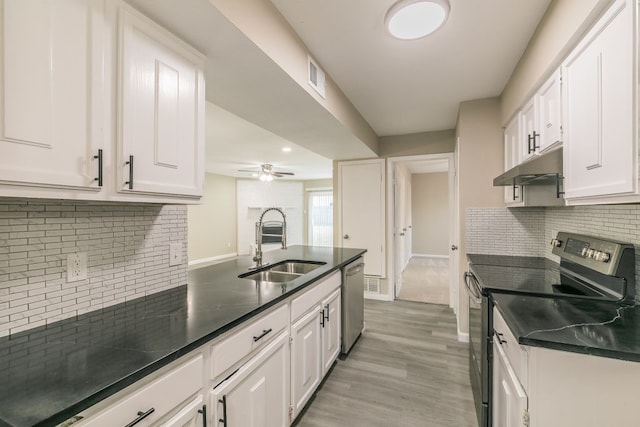 2400 Clearwood Dr, Arlington, TX 76014 - kitchen with stainless steel appliances, a sink, under cabinet range hood, white cabinets, and decorative backsplash