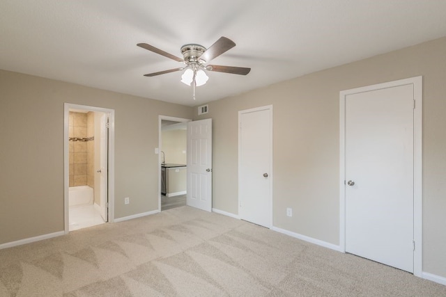 2400 Clearwood Dr, Arlington, TX 76014 - unfurnished bedroom with light colored carpet, baseboards, connected bathroom, and a ceiling fan