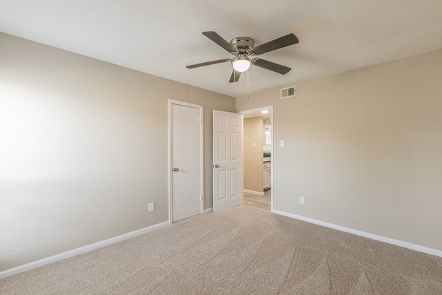 2400 Clearwood Dr, Arlington, TX 76014 - unfurnished bedroom featuring baseboards, light carpet, and a ceiling fan