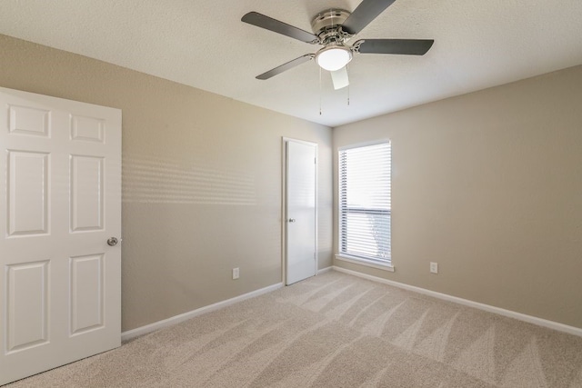 2400 Clearwood Dr, Arlington, TX 76014 - empty room featuring light colored carpet, a ceiling fan, and baseboards