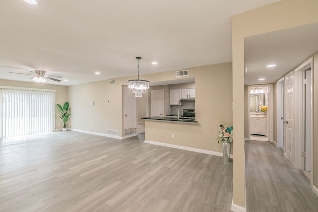 2400 Clearwood Dr, Arlington, TX 76014 - unfurnished living room with light wood finished floors, a ceiling fan, baseboards, a chandelier, and recessed lighting
