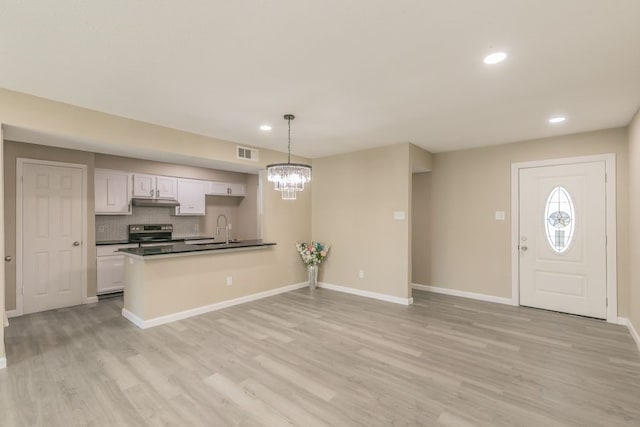 2400 Clearwood Dr, Arlington, TX 76014 - kitchen featuring electric range, dark countertops, light wood finished floors, a chandelier, and recessed lighting