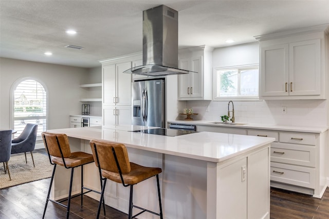 11750 Featherbrook Dr, Dallas, TX 75228 - kitchen with stainless steel fridge, island exhaust hood, a sink, plenty of natural light, and recessed lighting