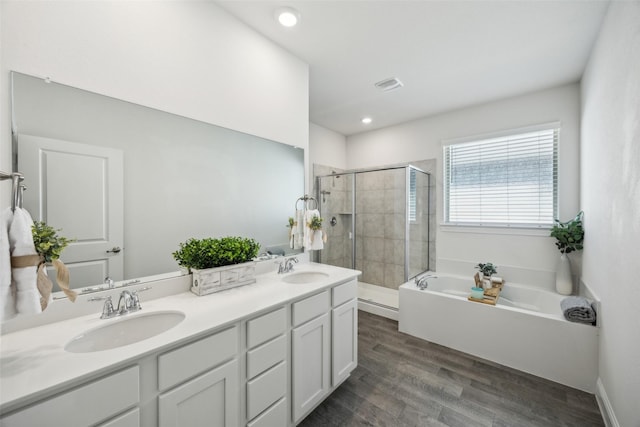 6217 Cheshire St, Celina, TX 76227 - bathroom with a shower stall, a garden tub, double vanity, wood finished floors, and recessed lighting