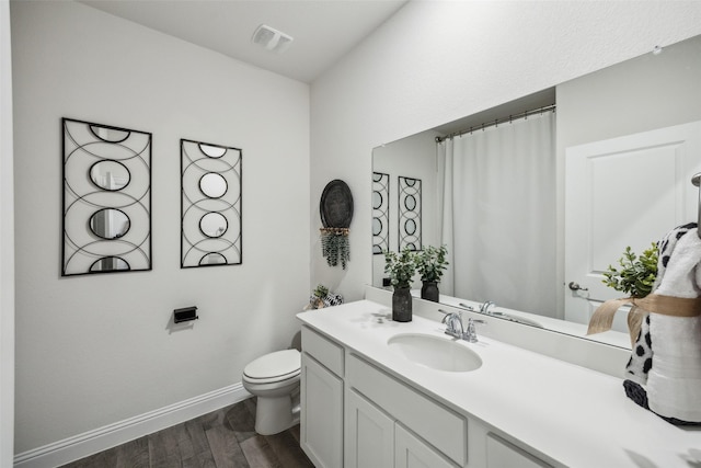 6217 Cheshire St, Celina, TX 76227 - full bathroom with wood finished floors, toilet, vanity, and baseboards